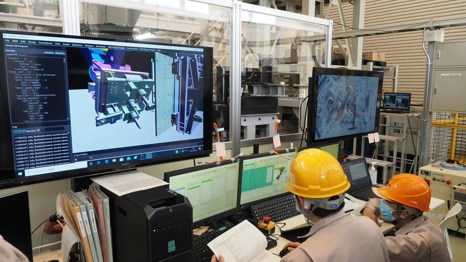 Engineers at workstations monitoring a remote-handling system in an ITER industrial setting